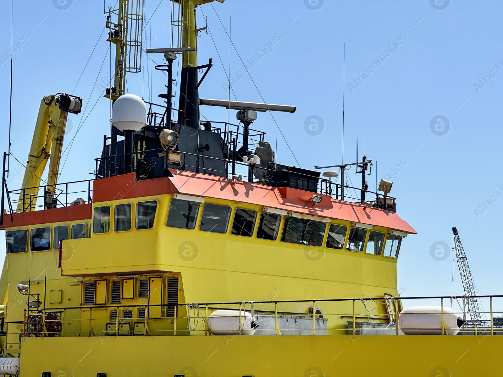 Photo of Ship moored in sea port on sunny day