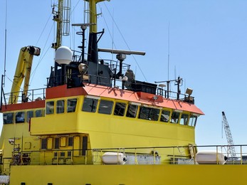 Ship moored in sea port on sunny day