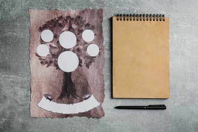 Photo of Blank family tree, notebook and pen on grey table, flat lay. Mockup for design