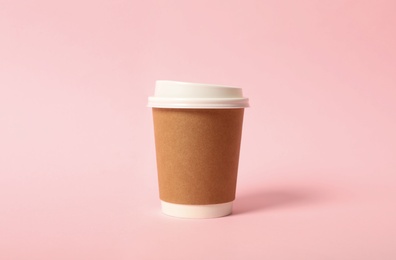 Takeaway paper coffee cup on pink background