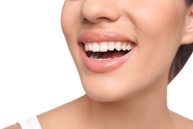 Photo of Young woman with beautiful smile on white background, closeup. Teeth whitening