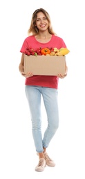 Photo of Young woman with box of fresh vegetables on white background