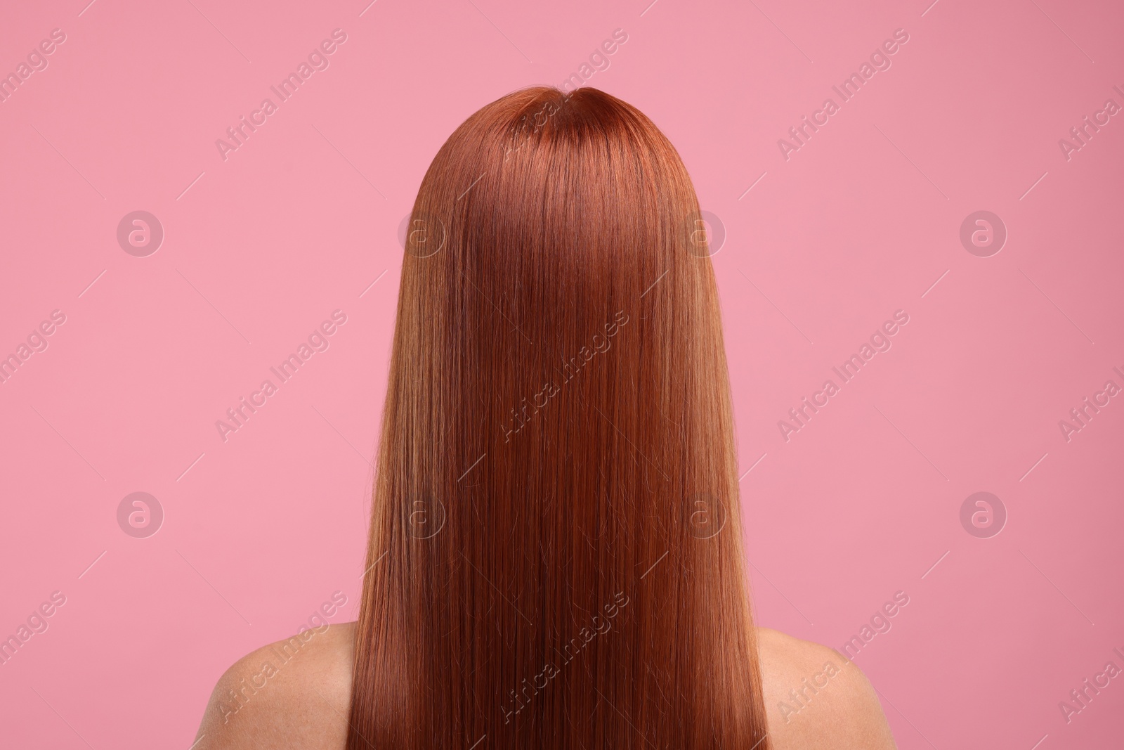 Photo of Woman with healthy hair after treatment on pink background, back view