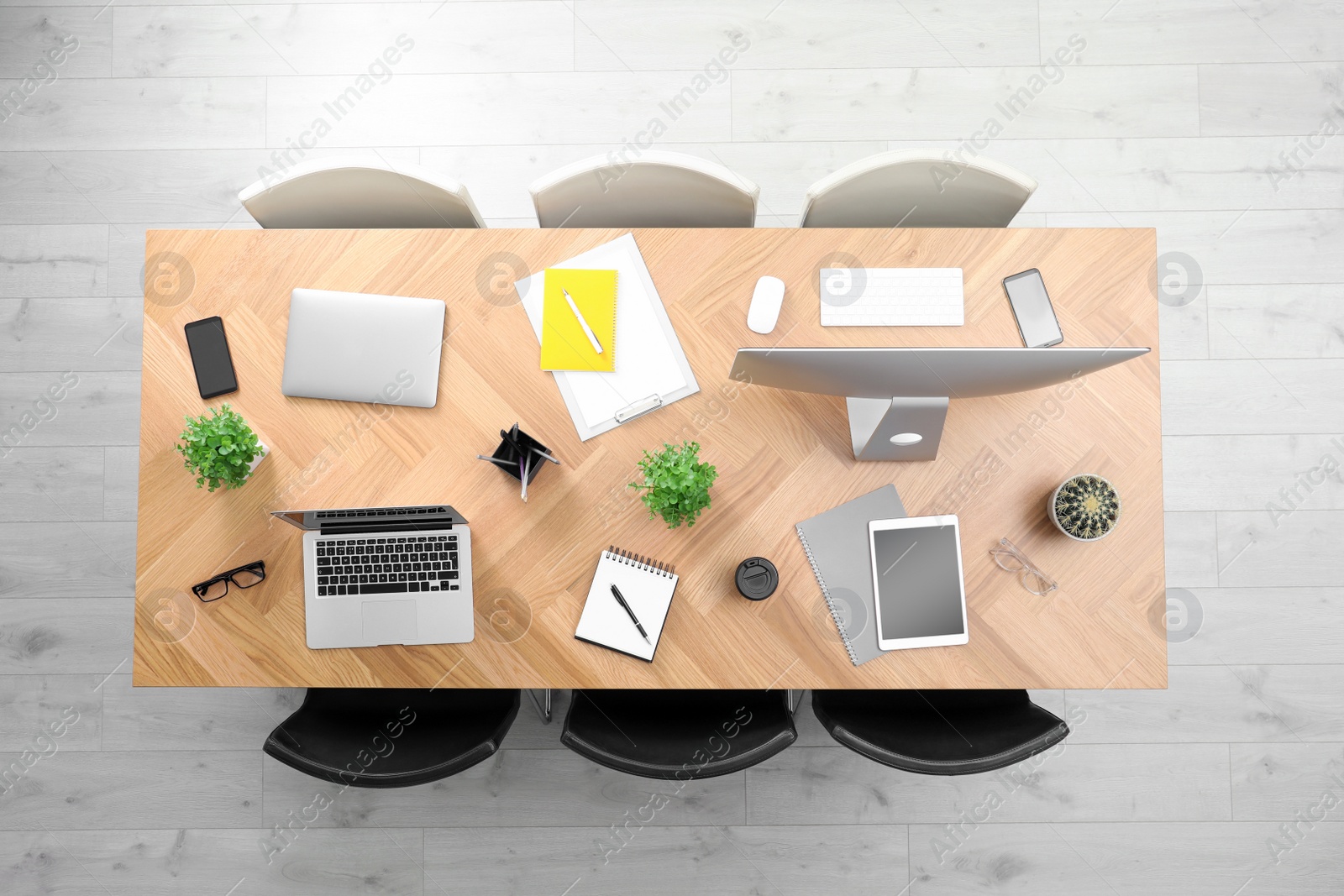 Photo of Modern office table with devices and chairs, top view