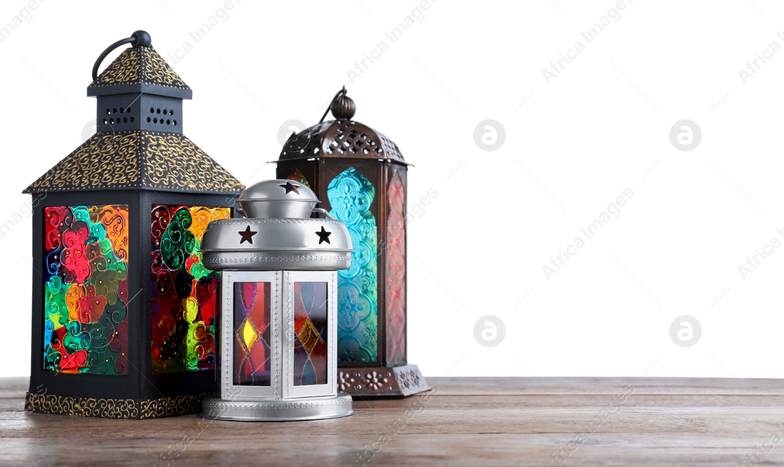 Photo of Decorative Arabic lanterns on wooden table against white background