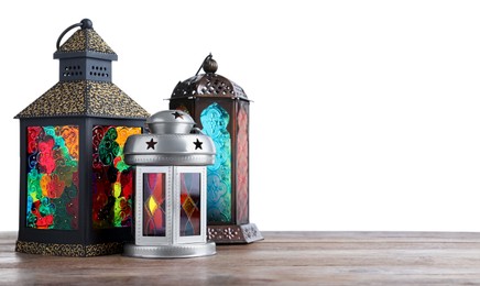 Photo of Decorative Arabic lanterns on wooden table against white background