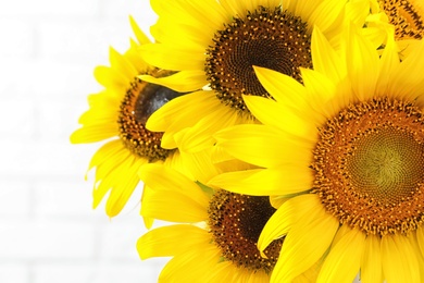 Bouquet of beautiful yellow sunflowers on light background