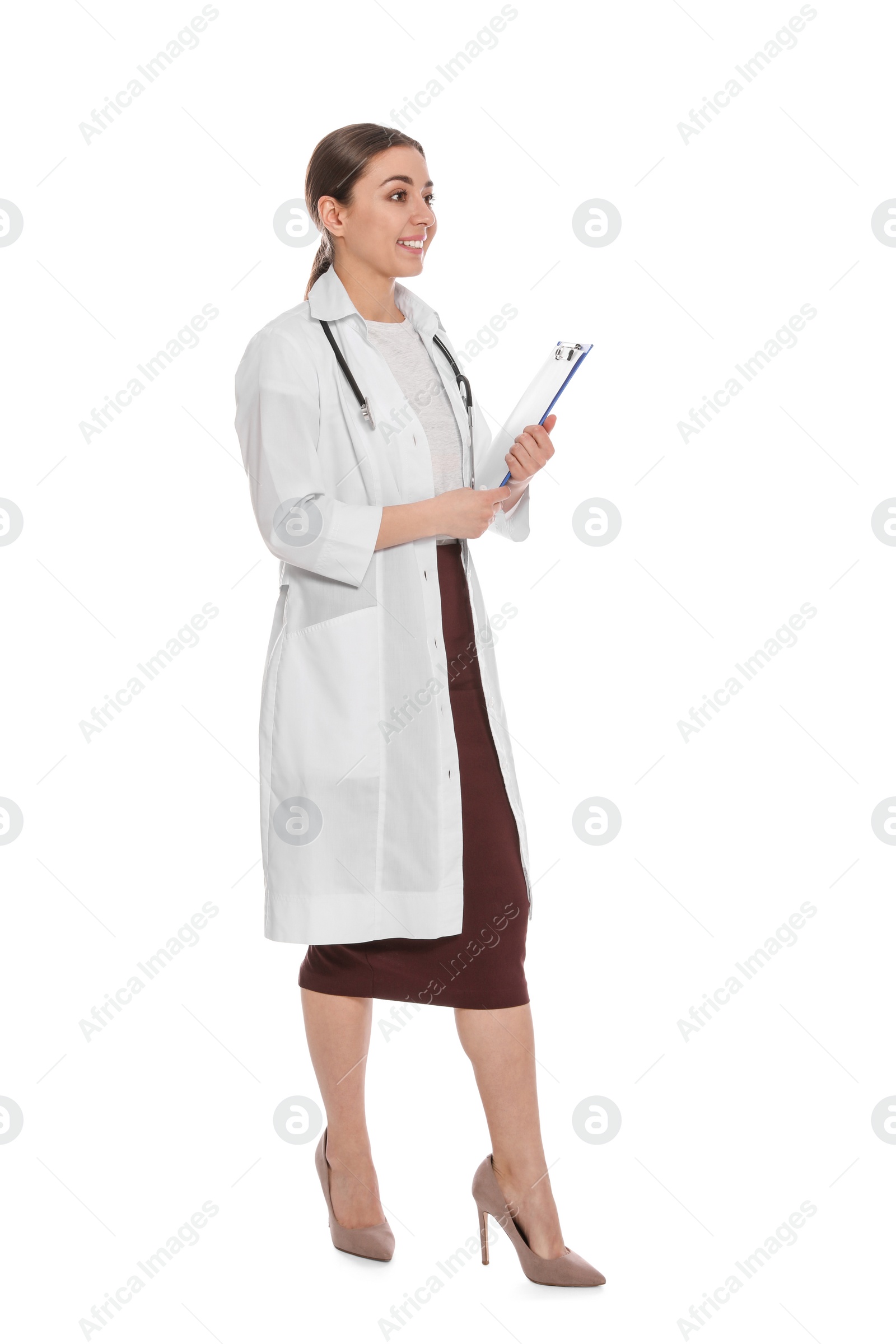 Photo of Full length portrait of medical doctor with clipboard and stethoscope isolated on white