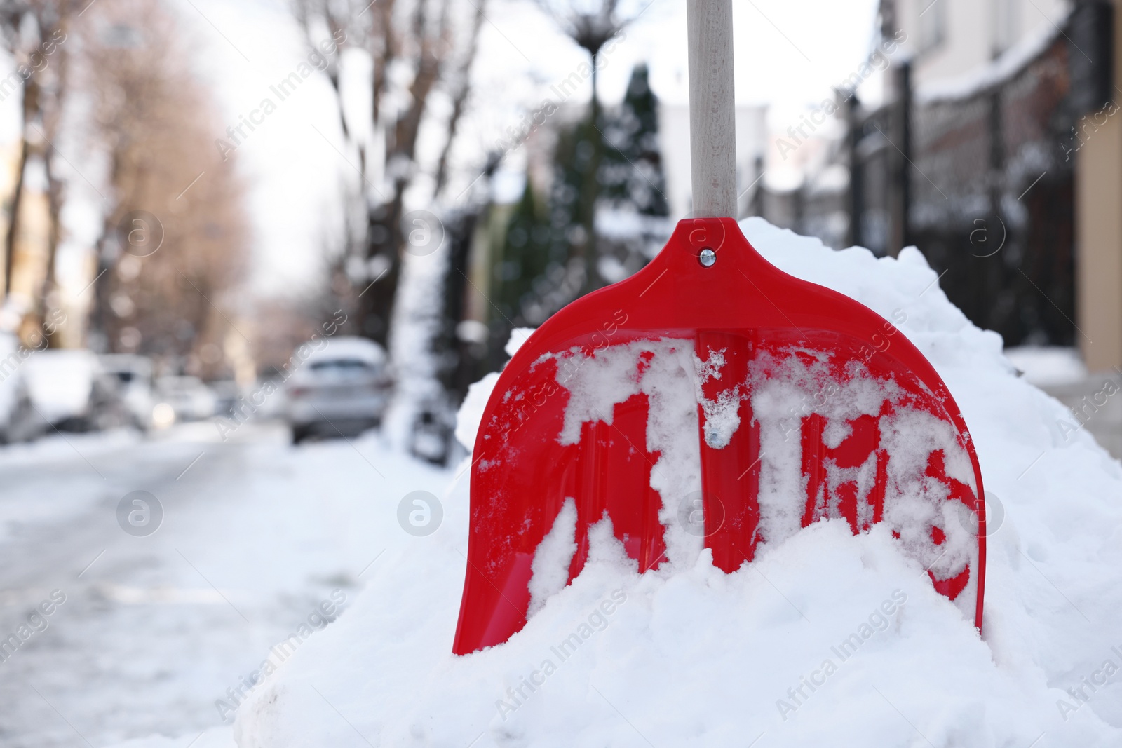 Photo of Snow shovel with wooden handle outdoors. Space for text