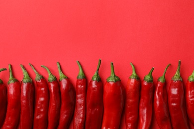 Photo of Flat lay composition with fresh chili peppers and space for text on color background