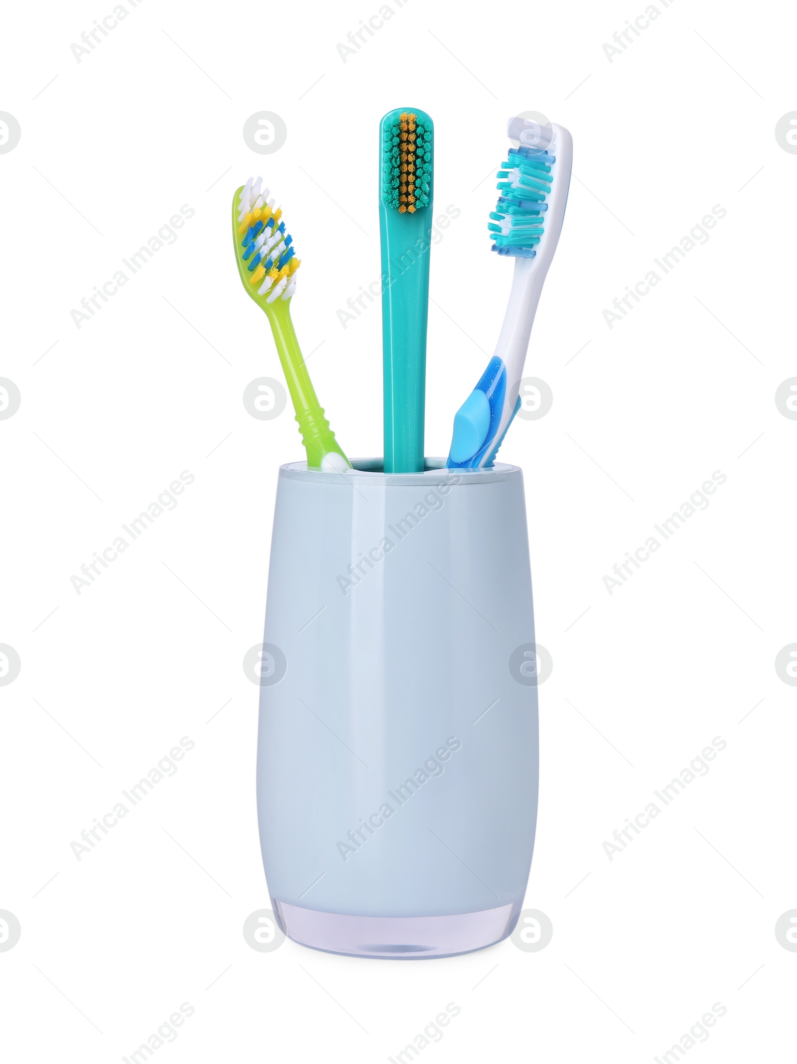 Photo of Different toothbrushes in holder isolated on white