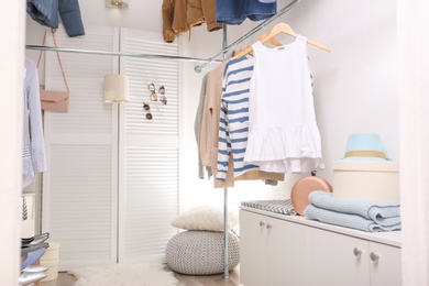 Modern dressing room with different stylish clothes and accessories