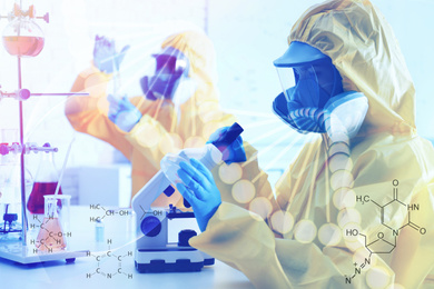 Image of Medical technology concept. Scientist in chemical protective suit using microscope at laboratory