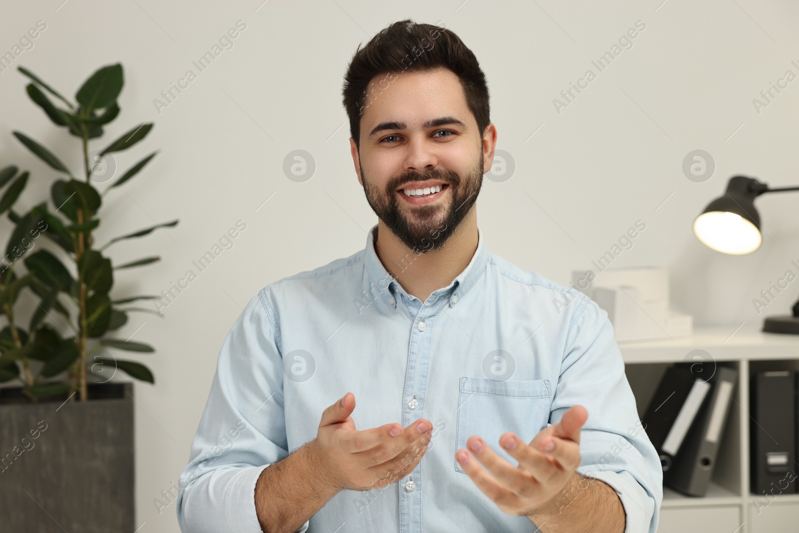 Photo of Young man having video chat indoors, view from web camera