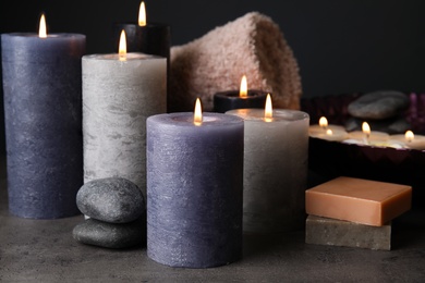 Photo of Spa composition with candles and cosmetic on table