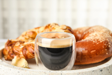 Fresh tasty pastries and coffee on tray, closeup