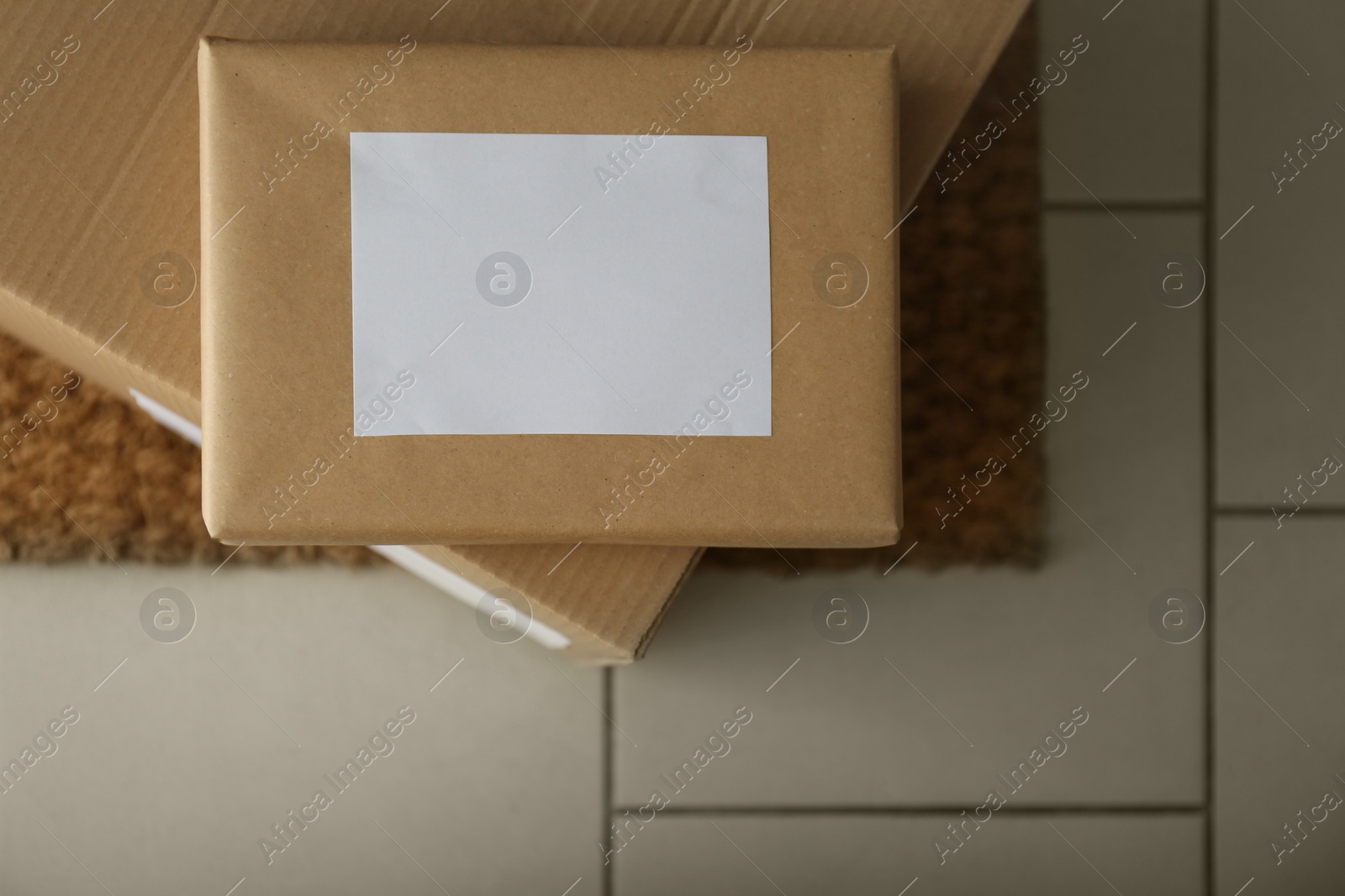 Photo of Parcels on rug near doorway. Delivery service
