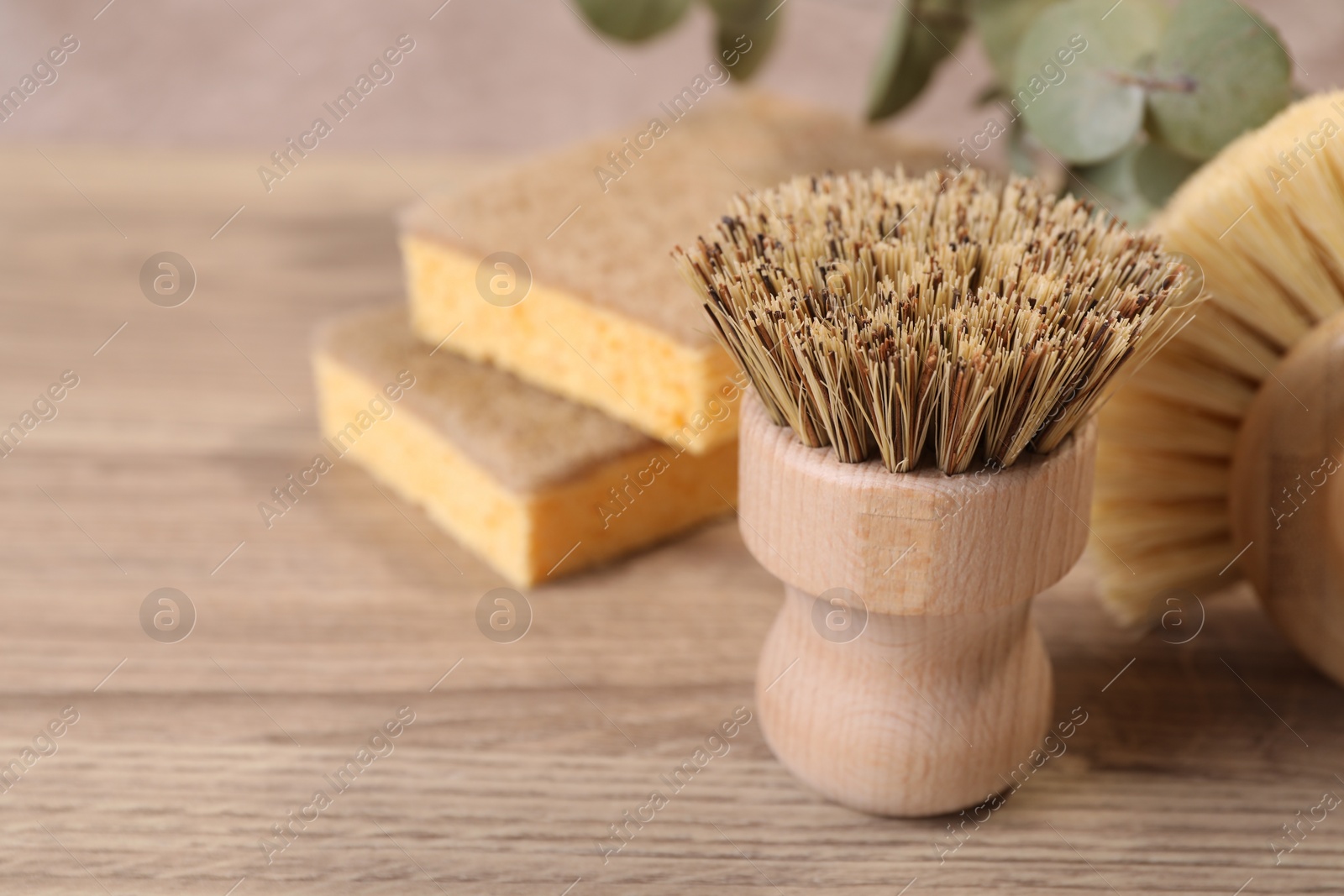 Photo of Small cleaning brush on wooden table, closeup. Space for text