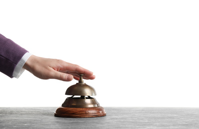 Woman ringing hotel service bell at grey stone table