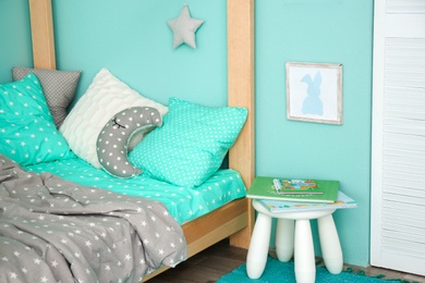 Photo of Comfortable bed in modern children room