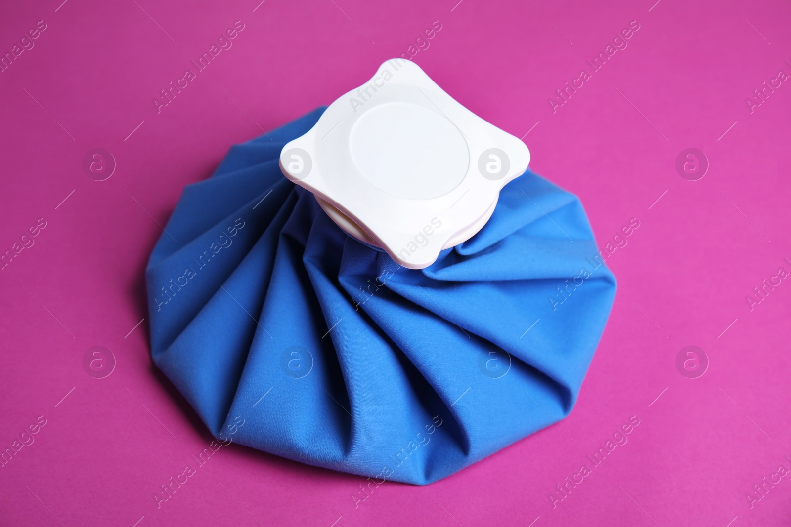 Photo of Ice pack on purple background. Cold compress