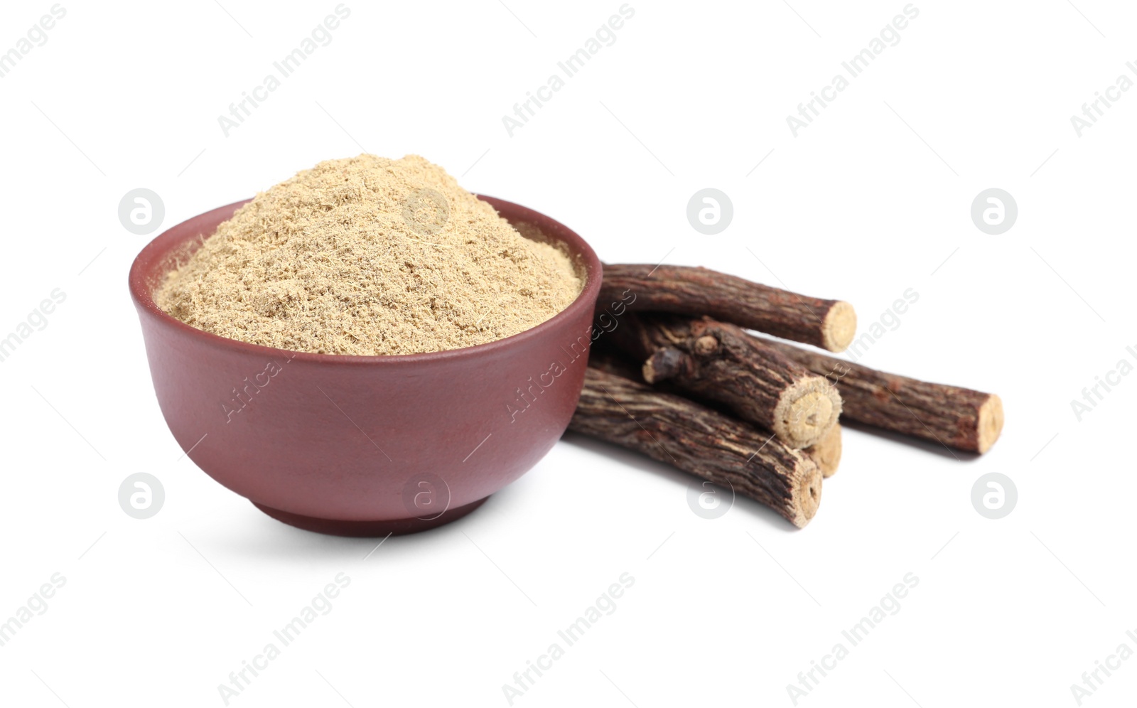 Photo of Powder in bowl and dried sticks of liquorice root on white background