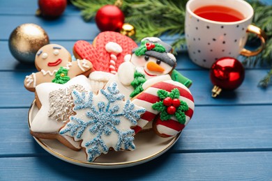 Delicious homemade Christmas cookies and festive decor on blue wooden table
