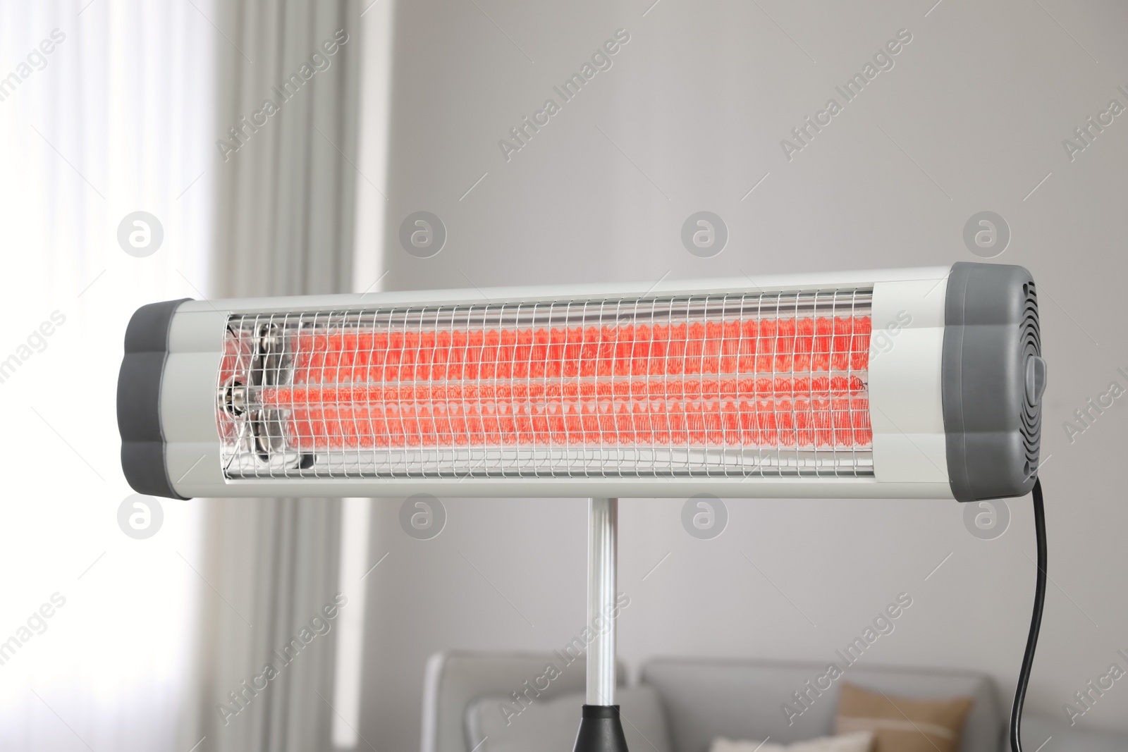 Photo of Modern electric infrared heater in living room