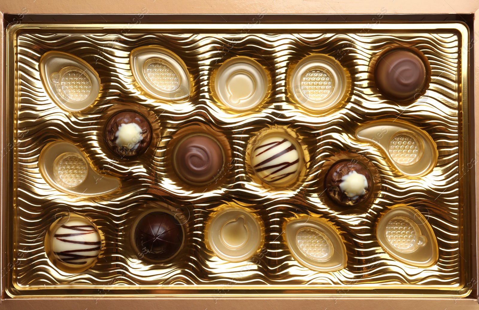 Photo of Partially empty box of chocolate candies as background, top view