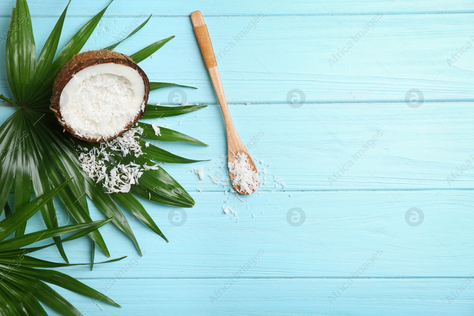 Photo of Composition with fresh coconut flakes on color wooden background, top view