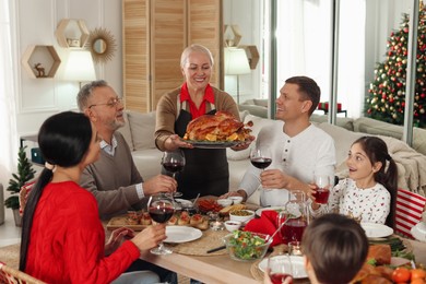 Photo of Happy family enjoying festive dinner at home. Christmas celebration