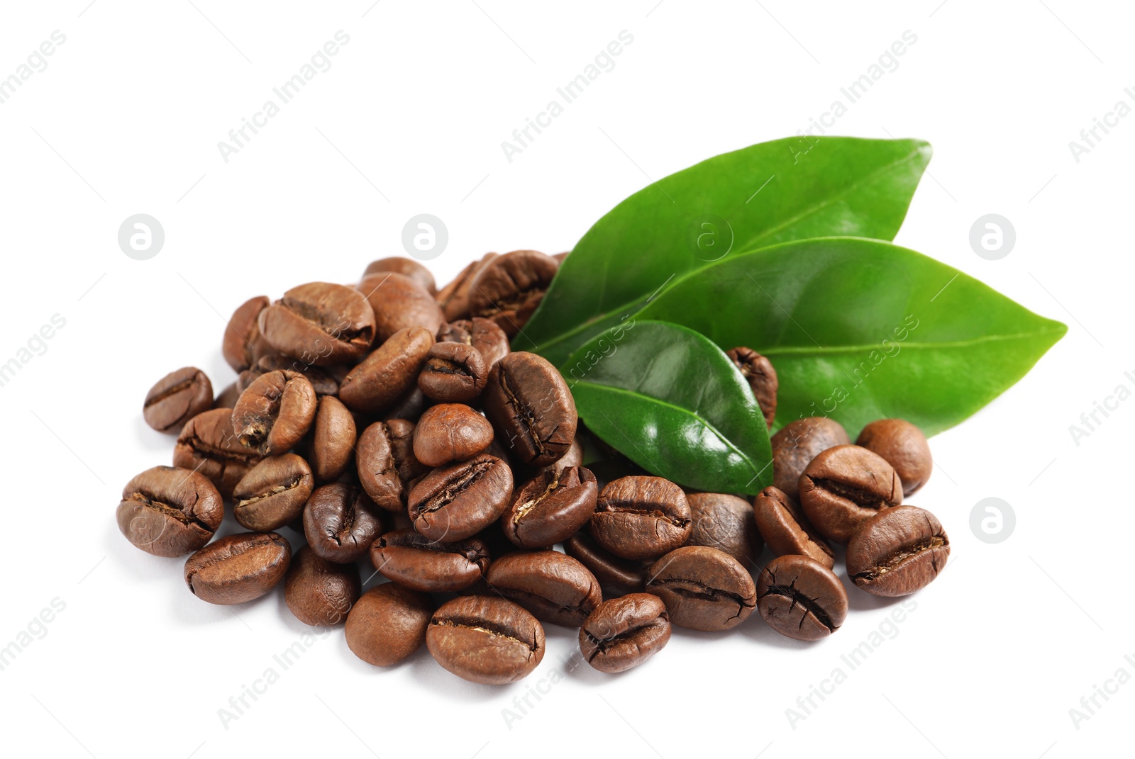 Photo of Roasted coffee beans and fresh green leaves on white background