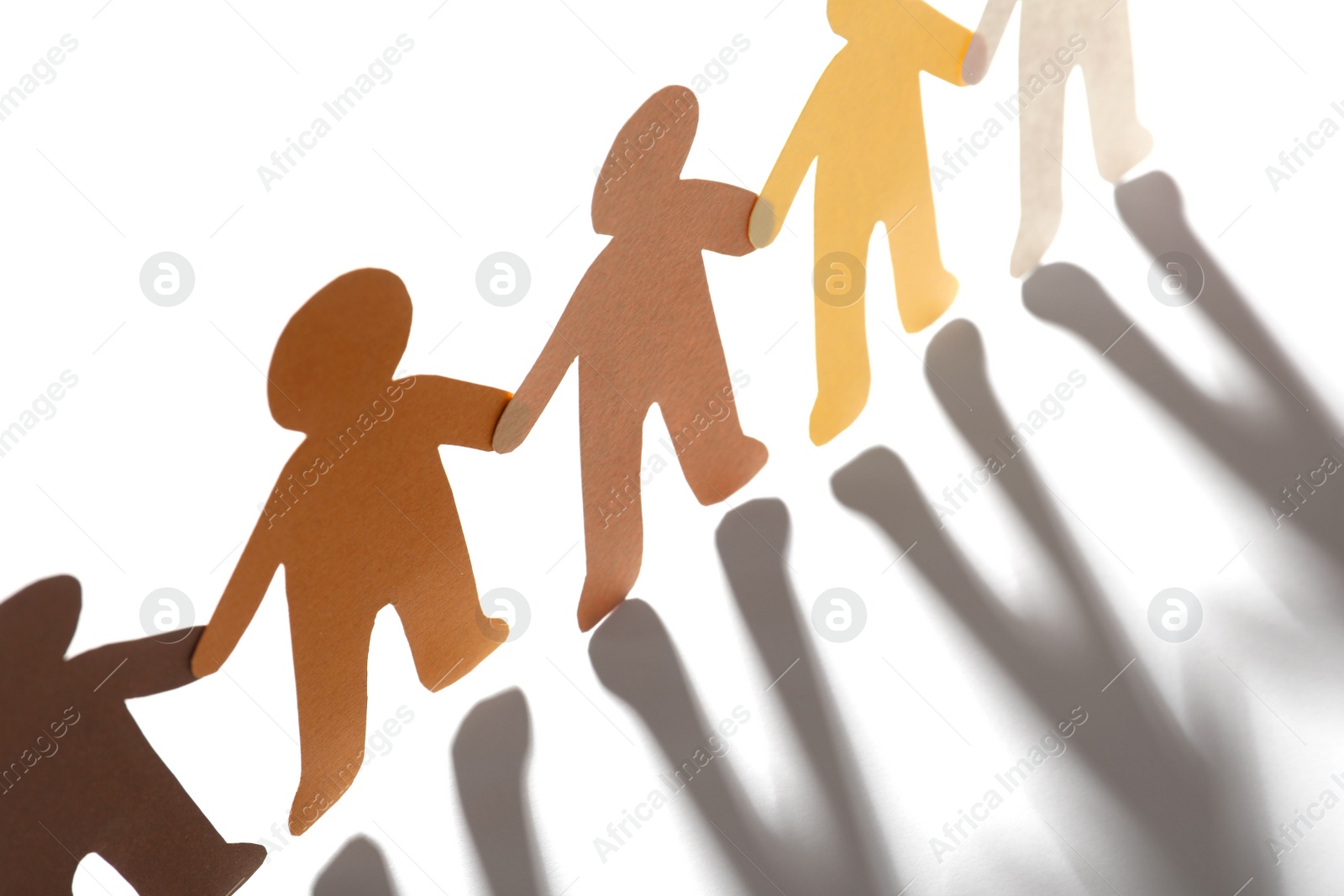 Photo of Paper people holding hands on light background. Unity concept