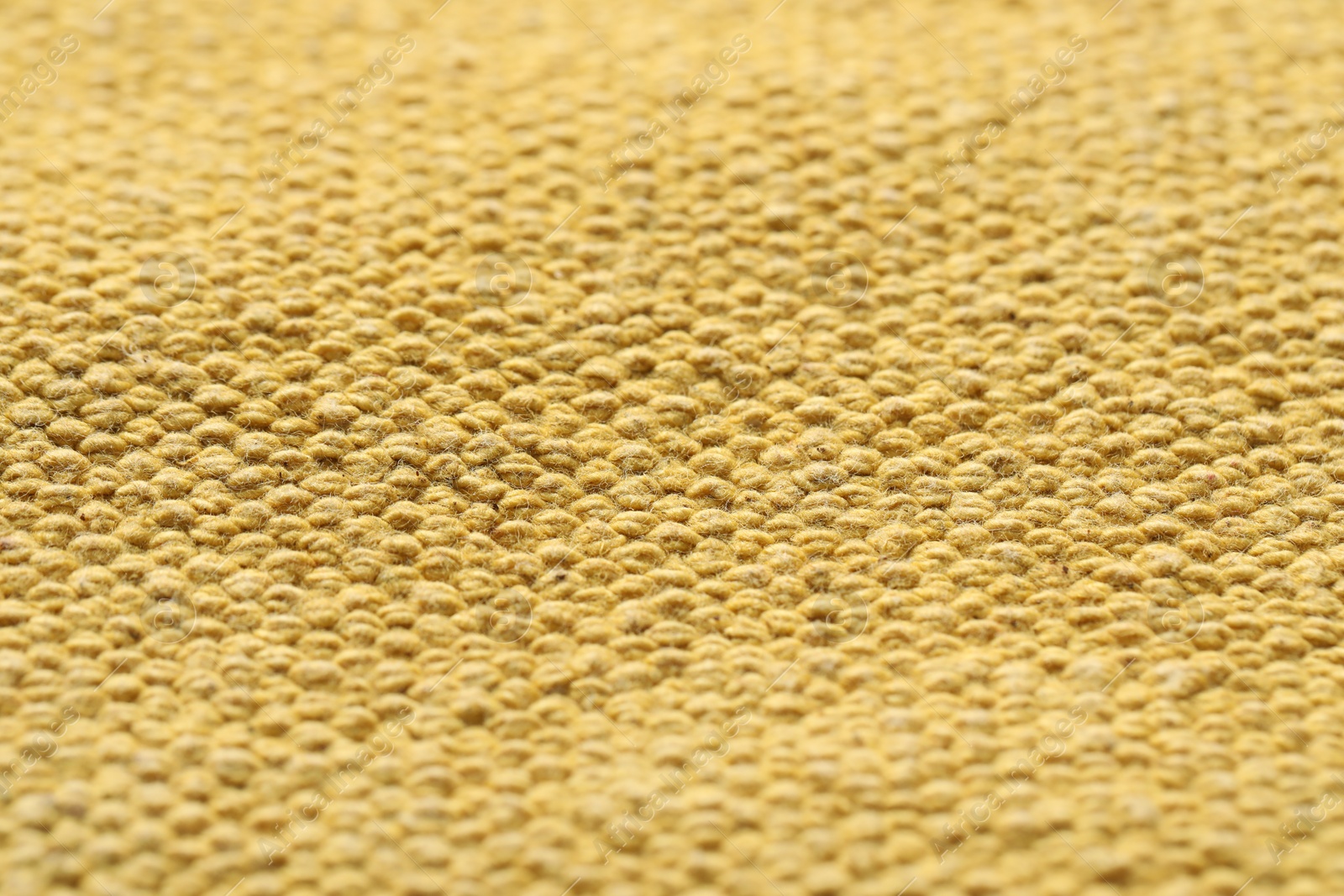 Photo of Texture of soft yellow fabric as background, closeup