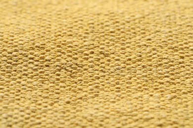 Photo of Texture of soft yellow fabric as background, closeup