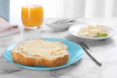 Photo of Fresh bread with tasty butter on plate