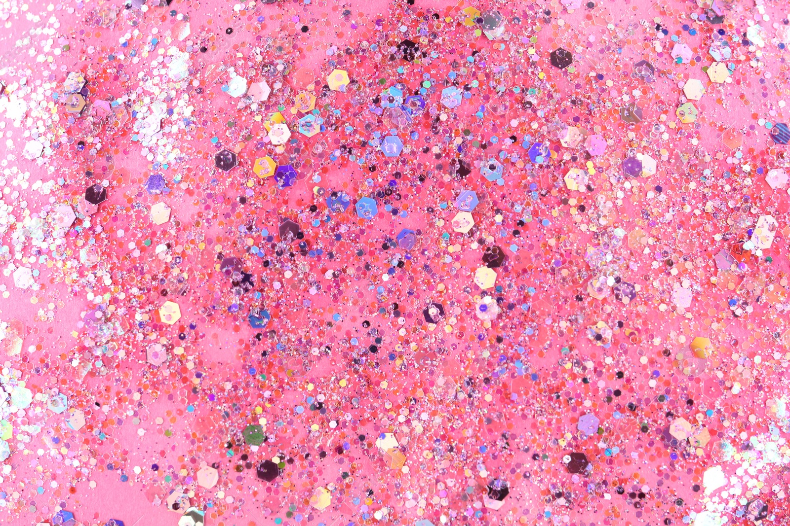 Photo of Shiny glitter on pink background, top view