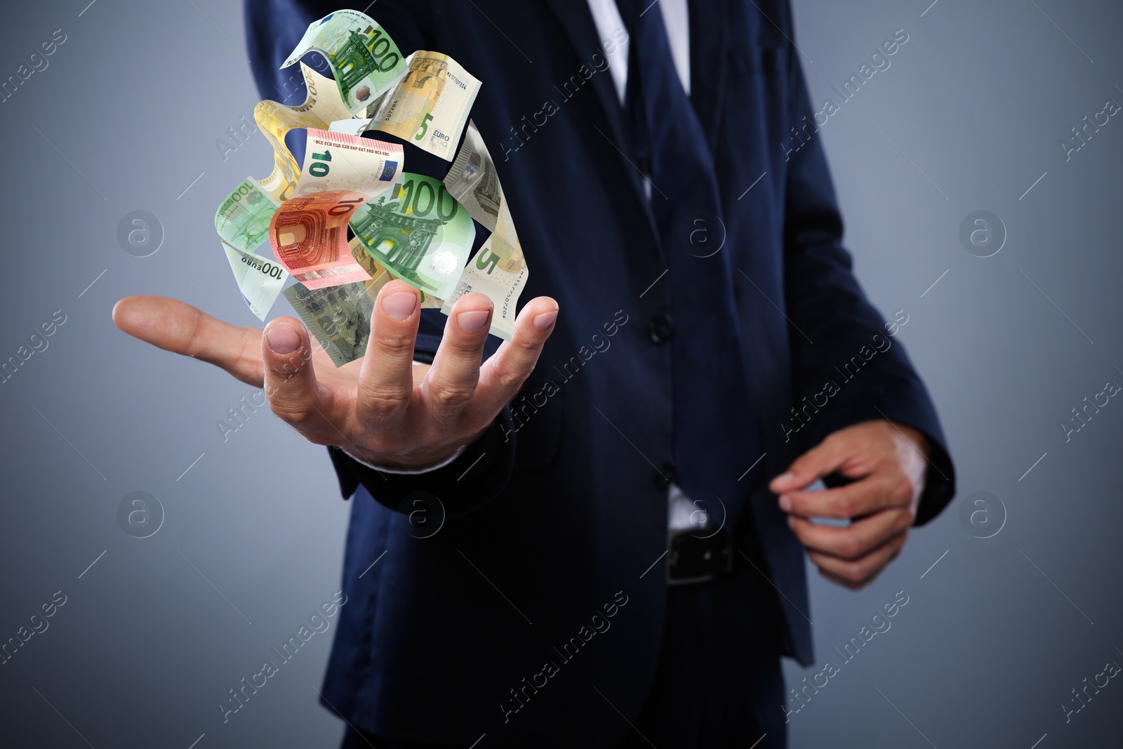 Image of Businessman with money on grey background, closeup. Currency exchange