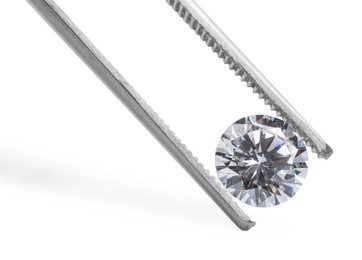 Photo of Tweezers with beautiful shiny diamond isolated on white