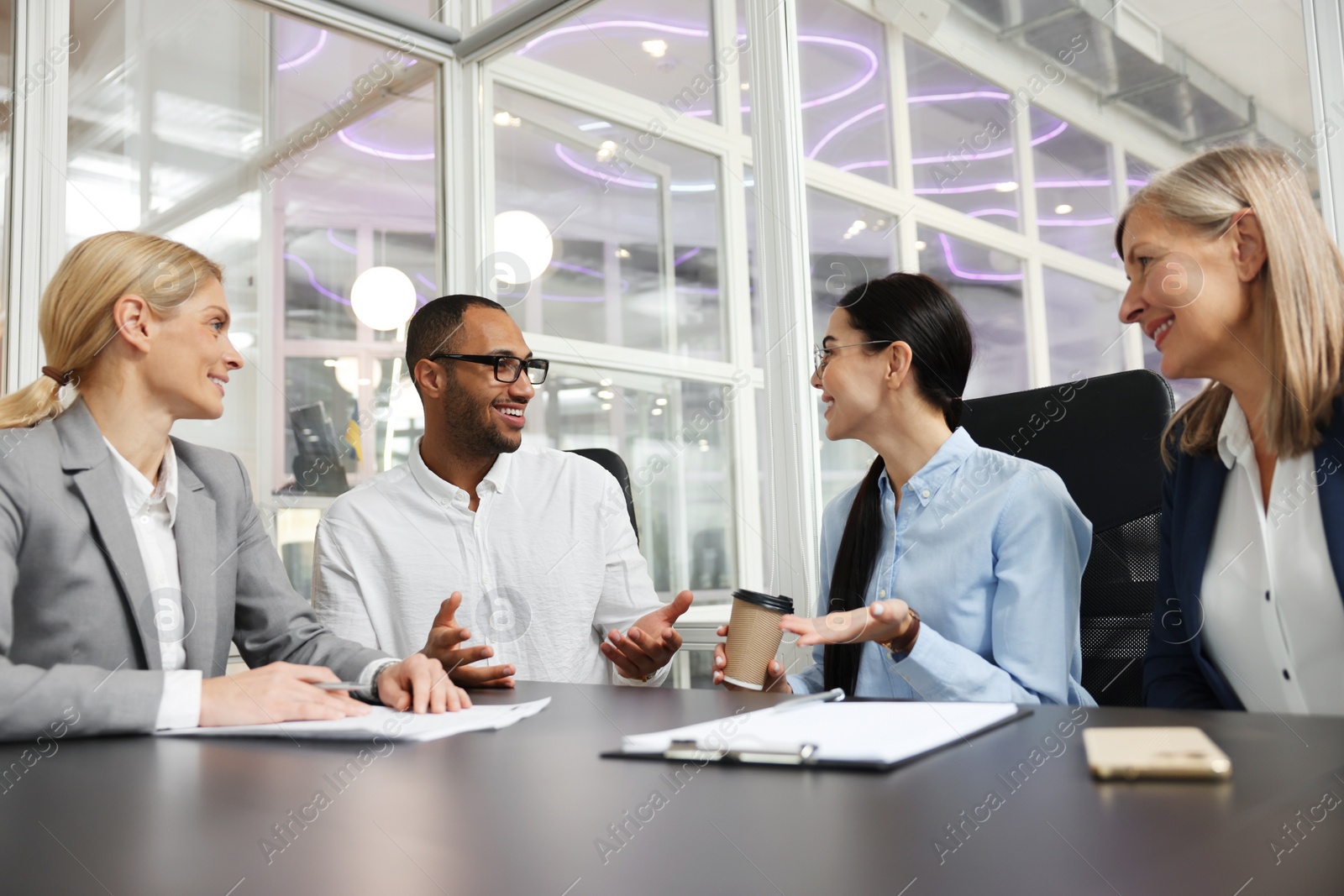 Photo of Lawyers working together at table in office