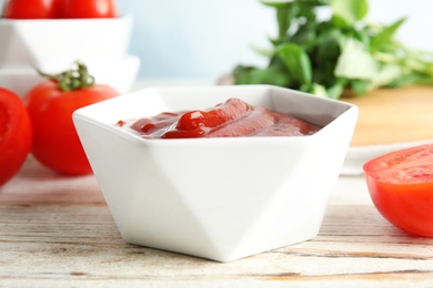 Photo of Bowl with homemade tomato sauce on table