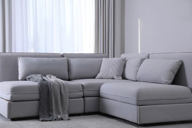 Large grey sofa in living room. Interior design