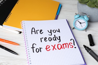 Photo of Notebook with question Are You Ready For Exams? on white wooden table