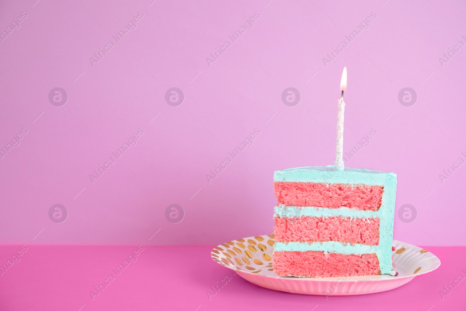 Photo of Slice of fresh delicious birthday cake with candle on table against color background. Space for text