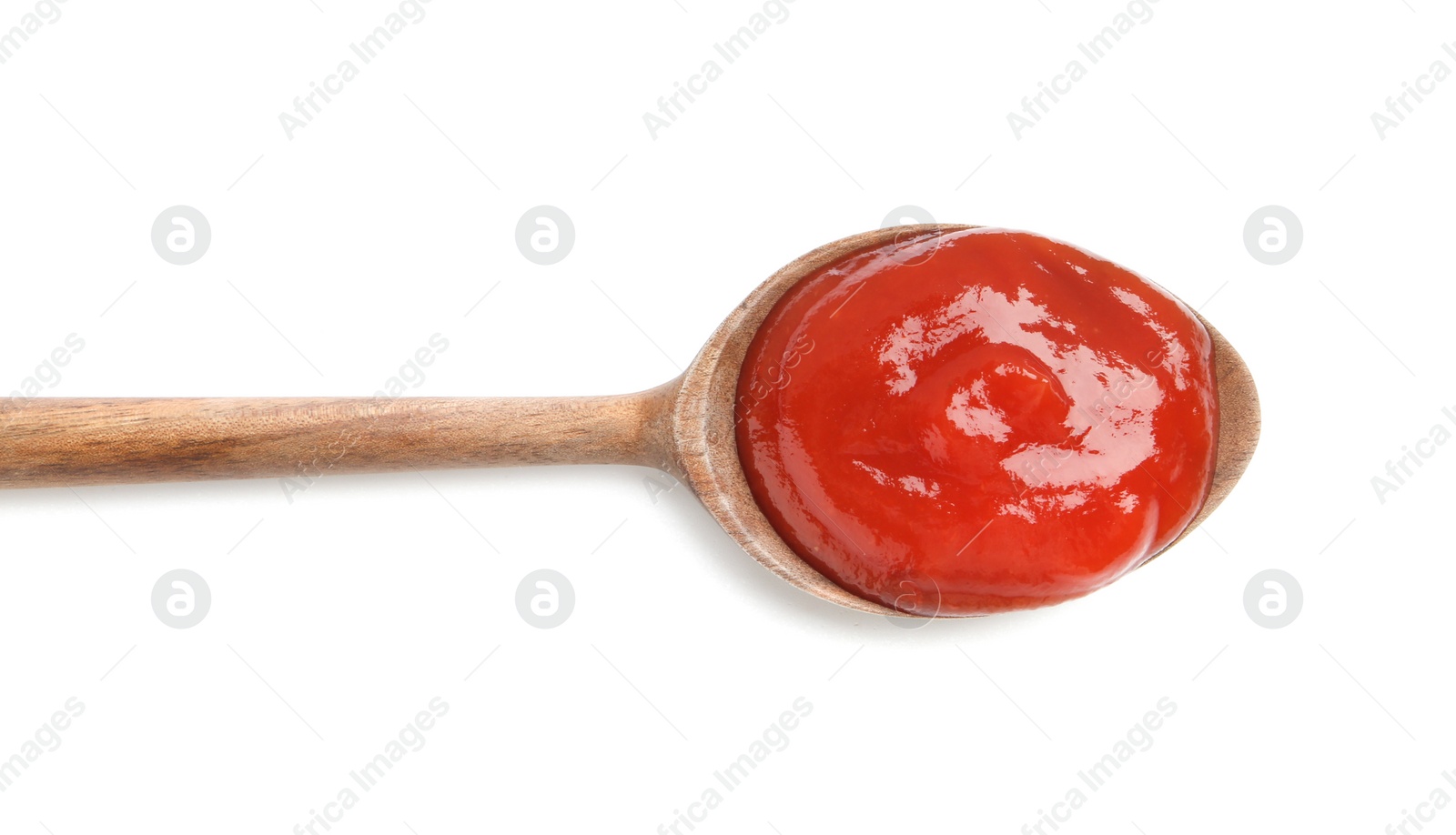 Photo of Tasty ketchup with wooden spoon isolated on white, top view. Tomato sauce