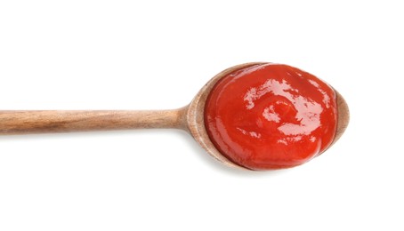 Photo of Tasty ketchup with wooden spoon isolated on white, top view. Tomato sauce