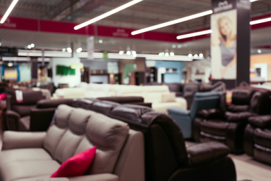 Blurred view of furniture store in mall. Bokeh effect