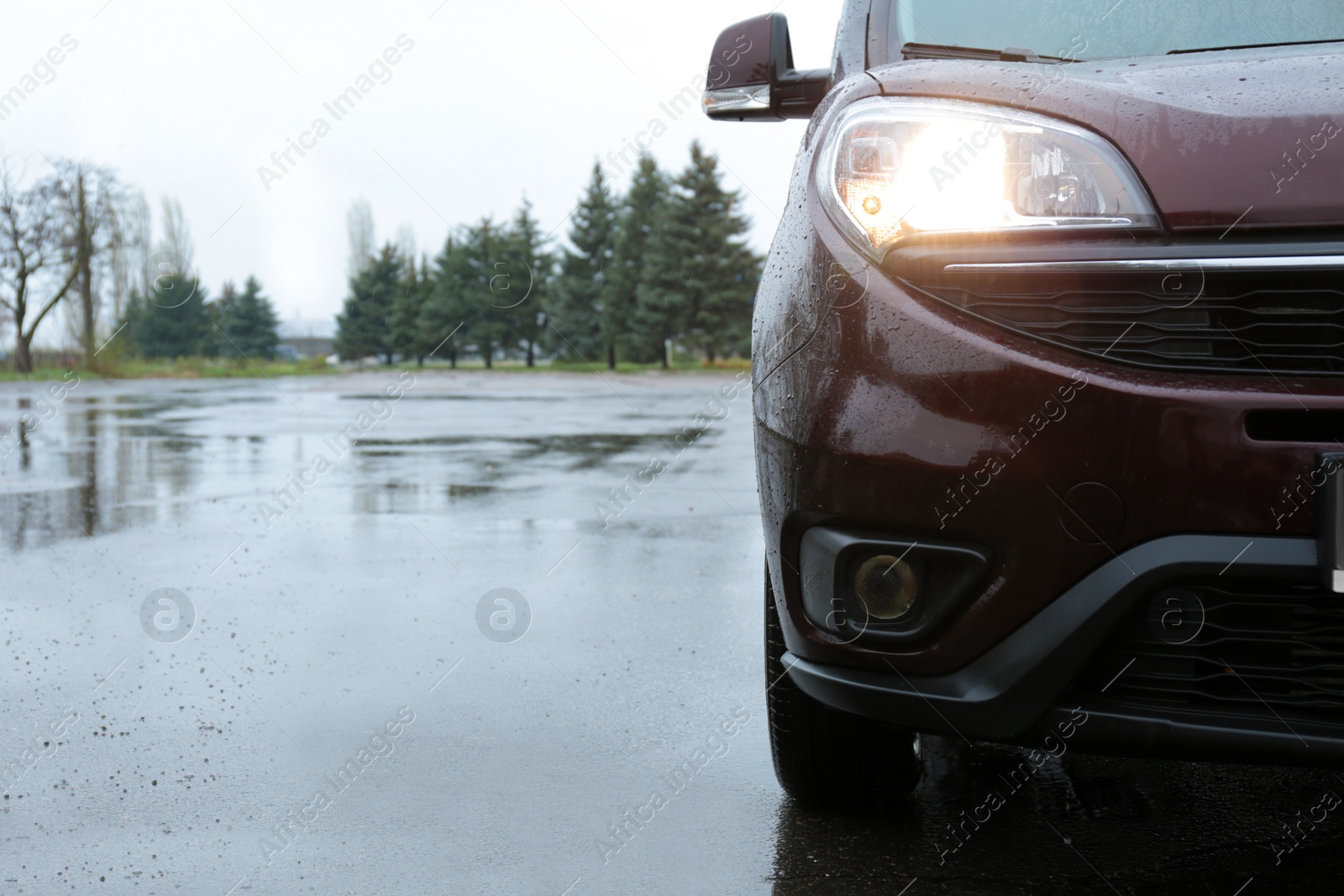 Photo of Car parked outdoors on rainy day, closeup