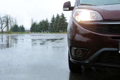 Photo of Car parked outdoors on rainy day, closeup