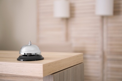 Photo of Service bell on reception desk in hotel, closeup